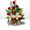 Red roses and white lilies in a white vase with a birthday pick