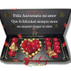 Black gift box with red roses and gold chocolates arranged as a heart and letters