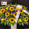 A stunning casket spray* designed to honor a beautiful life with warmth