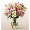Pink and white mixed flowers in a clear glass vase