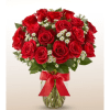 Bouquet of red roses and white filler flowers in a glass vase with a red ribbon