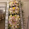 Tall standing floral wreath with white and pink flowers and Korean condolence ribbons