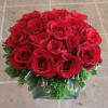 Red roses arranged in a low glass vase