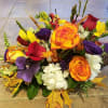 Bouquet of orange, red, purple, and white flowers with autumn leaves