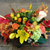 Colorful floral arrangement with calla lilies, roses, and orchids