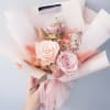 Pink and cream rose bouquet wrapped in pale paper