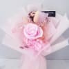 Pink rose bouquet with hydrangea and delicate filler flowers wrapped in pale pink paper