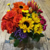 Bouquet of red roses, orange gerbera daisies, yellow sunflowers, and pink tulips