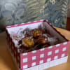 Box of wrapped chocolate candies in pink and white packaging
