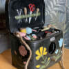 Decorative black sewing box with miniature tools and floral painted accents