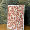 Floral greeting card with coral flower pattern in a clear sleeve