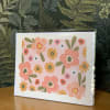 Floral greeting card with pink and orange flowers in a clear sleeve