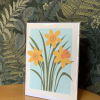 Greeting card with stylized yellow flowers on a blue background