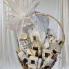 Gift basket with bath and body products tied with a large white bow