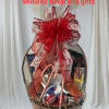 Gift basket with assorted snacks and candy, topped with a red ribbon bow
