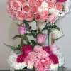 Pink and white rose arrangement in a glittery rectangular container