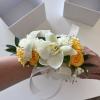 White orchid wrist corsage with yellow roses and ribbon