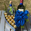 Heart-shaped gift box with blue roses, chocolates, and two liquor bottles