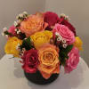 Colorful rose bouquet in a black vase