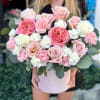Pink and white roses with carnations in a round blush box