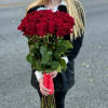 Large bouquet of red roses with a red ribbon wrap