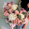 Bouquet of pink roses, white hydrangeas, and purple filler flowers