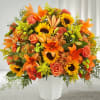 Orange and yellow mixed bouquet in a white vase
