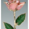 Pink rose-shaped ornament with green leaves and gold trim