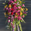 Tall standing floral spray with pink, purple, and yellow flowers