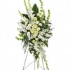 Standing floral spray of white and pale yellow flowers on an easel