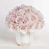 Bouquet of pale pink roses in a white vase
