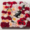 Square floral gift box with roses, poppies, and champagne bottles
