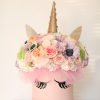 Pastel flower arrangement in a pink unicorn box with a gold horn