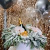 Champagne bottle in a white box with pink orchids and silver ornaments