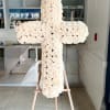 Large white rose cross on a wooden easel