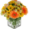 Bouquet of yellow and orange flowers in a clear glass vase