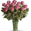 Pink roses arranged in a clear glass vase