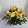 This noble arrangement includes seven yellow roses with three green hydrangeas, designed