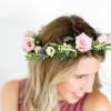 Woman wearing a pink floral crown with small blossoms