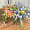 Large colorful floral arrangement on a wooden table