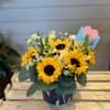Sunflower bouquet in a dark vase with a pink heart pick