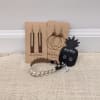 Assorted earrings and braided bracelets displayed on cards and a table