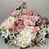 Clusters of pastels and pink roses mingle with large white hydrangea blooms