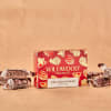 Box of Wildwood chocolate caramels with wrapped candies on a tan background