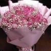 Pink rose bouquet with baby's breath wrapped in pink paper