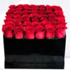 Box of red roses in a black square container
