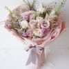 Pink and white rose bouquet wrapped in pale pink paper