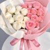 Bouquet of pink and white roses wrapped in pink and white paper
