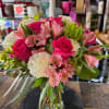 Pink roses and white carnations in a glass vase