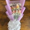 Pink tulip bouquet with white filler flowers and a large white bow